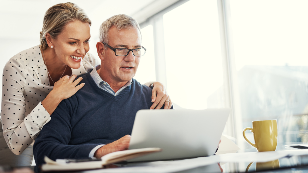 Persone vicine alla pensione che cercano informazioni sull’età pensionabile e la pianificazione previdenziale al computer.